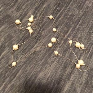 Long strand plastic pearl necklace